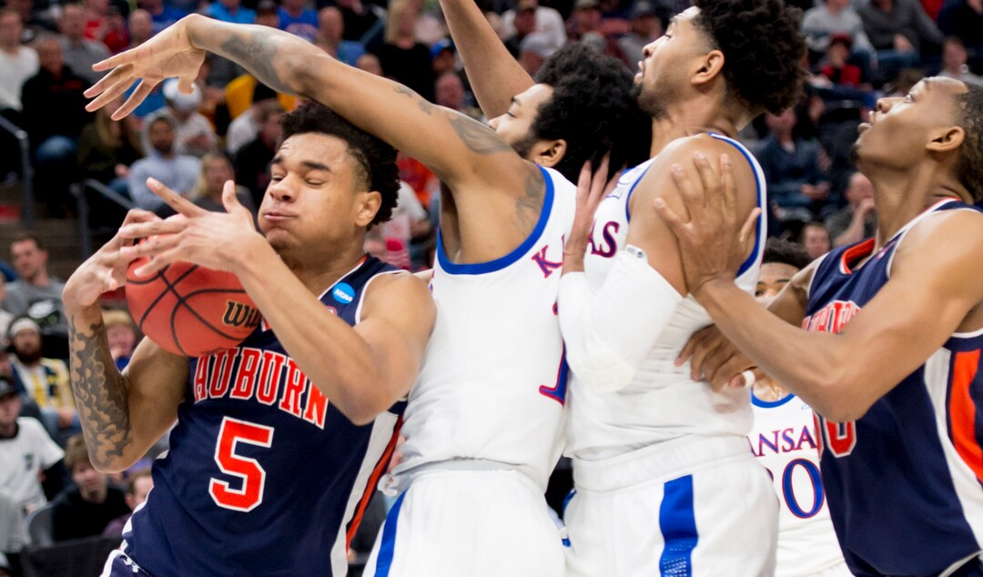 (Leah Hogsten  | The Salt Lake Tribune)  Auburn Tigers forward Chuma Okeke (5) gets blocked by Kansas Jayhawks guard K.J. Lawson (13) as Auburn faces Kansas in the second round of the NCAA tournament in Salt Lake City on Saturday, March 23, 2019.