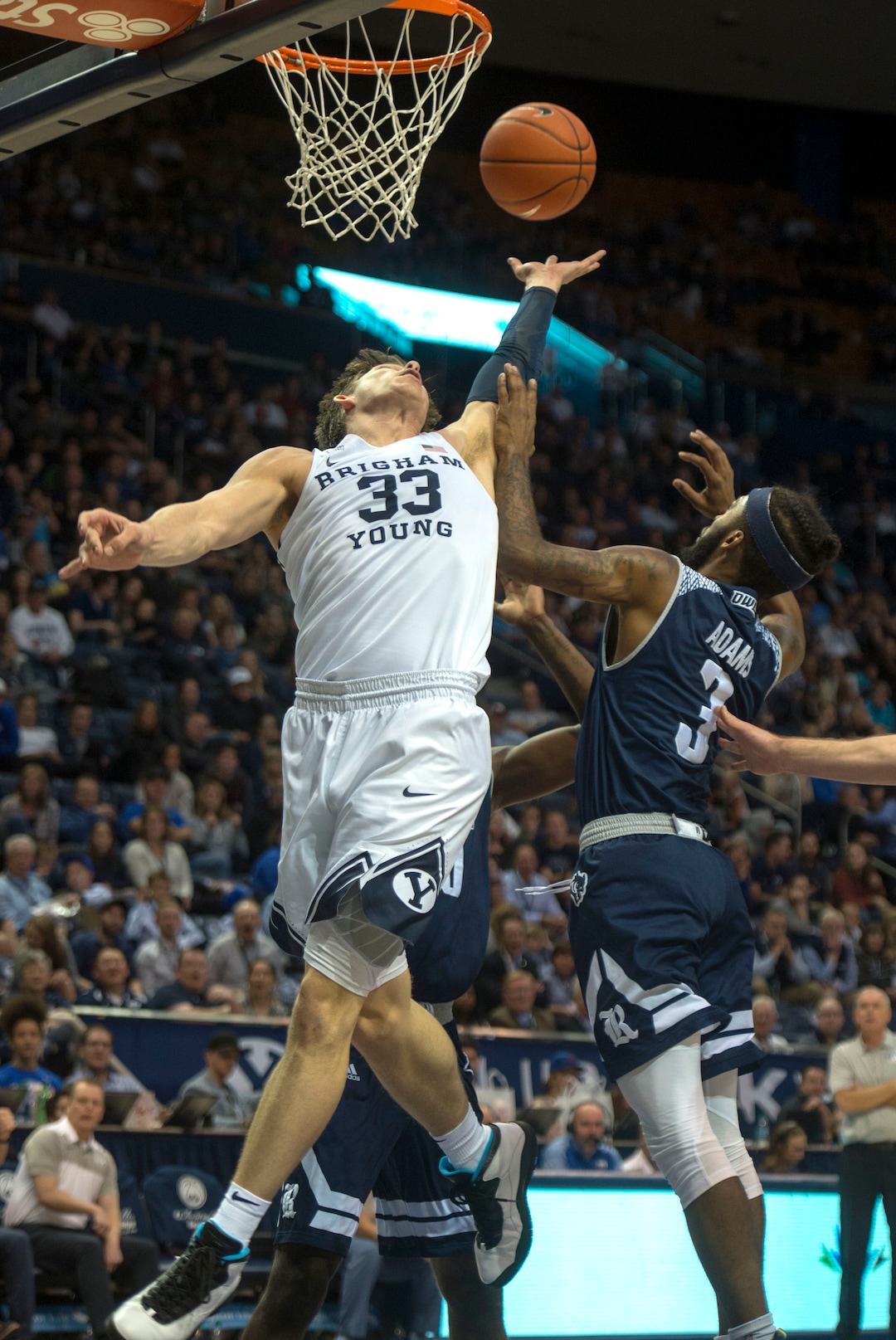 (Rick Egan  |  The Salt Lake Tribune)  Brigham Young Cougars forward Dalton Nixon (33) goes for a rebound along with Rice Owls guard Ako Adams (3), in basketball action between Brigham Young Cougars and Rice Owls, at the Marriott Center in Provo, Wednesday, Nov. 21, 2018.