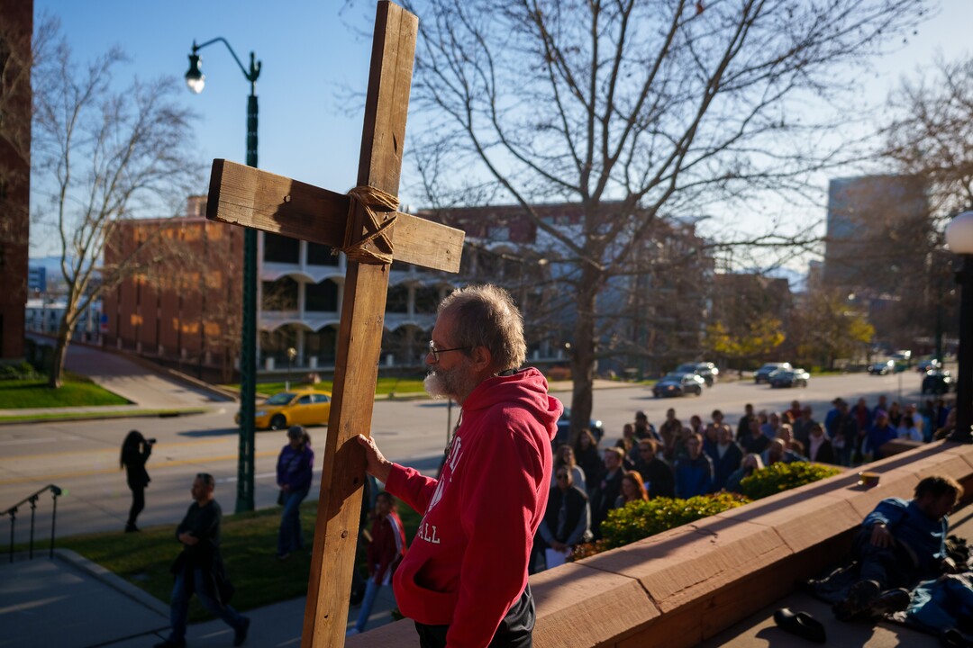(Trent Nelson  |  The Salt Lake Tribune) Alex Bury carries the cross as a Good Friday procession to the First Presbyterian Church in Salt Lake City on Friday, April 15, 2022.