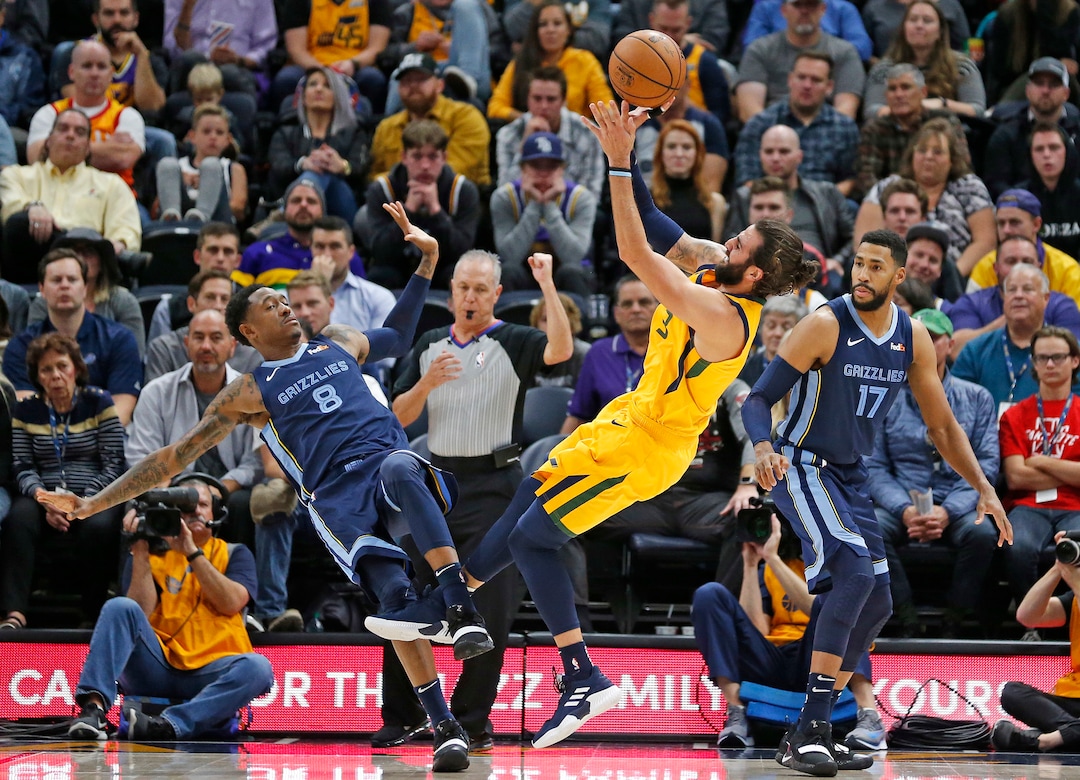 Utah Jazz guard Ricky Rubio (3) shoots as Memphis Grizzlies' MarShon Brooks (8) and Garrett Temple (17) defend in the first half during an NBA basketball game Monday, Oct. 22, 2018, in Salt Lake City. (AP Photo/Rick Bowmer)