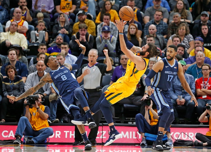Utah Jazz guard Ricky Rubio (3) shoots as Memphis Grizzlies' MarShon Brooks (8) and Garrett Temple (17) defend in the first half during an NBA basketball game Monday, Oct. 22, 2018, in Salt Lake City. (AP Photo/Rick Bowmer)