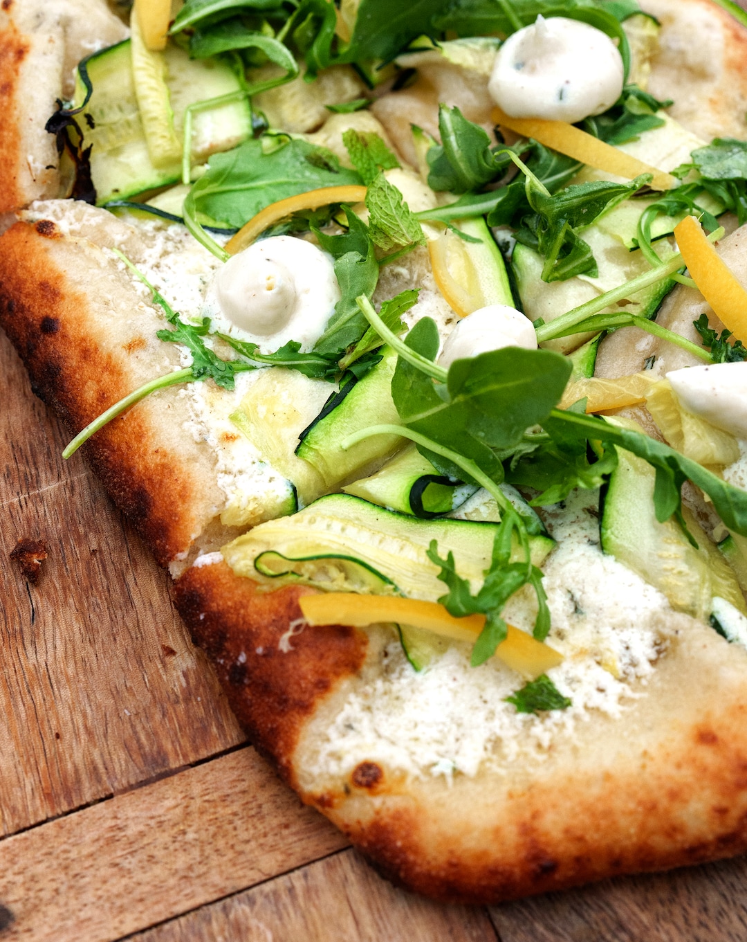 (Leah Hogsten | The Salt Lake Tribune) Emigration Cafe's Zucchini pinsa with ricotta, basil, mint and preserved lemons, $13, April 27, 2022. Emigration Cafe's menu features Roman style wood fired pizza, salads, sandwiches and mains.