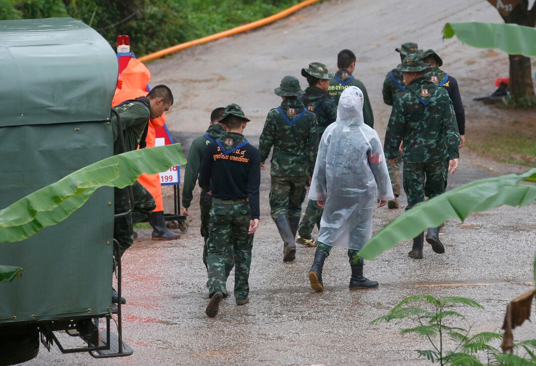 Rescuers move to the entrance to a cave complex where five stil lwere trapped in Mae Sai, Chiang Rai province, northern Thailand Tuesday, July 10, 2018. The eight boys were rescued from the flooded cave. (AP Photo/Sakchai Lalit)