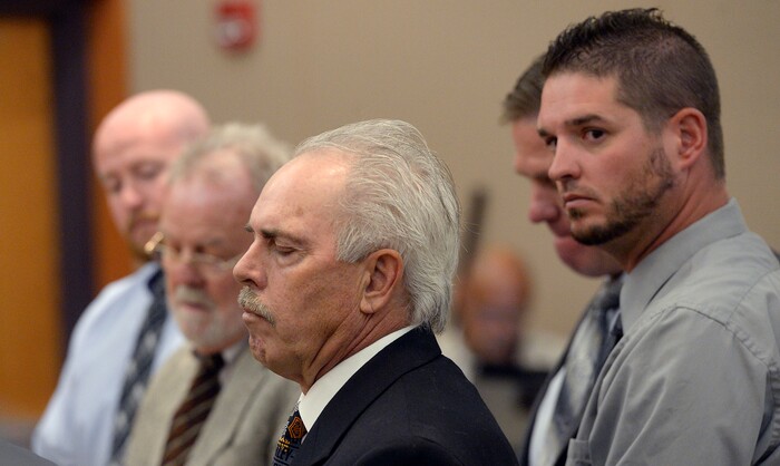 (Al Hartmann | Tribune file photo) Former Daggett County Sheriff Jerry Jorgensen, front left, talks with lawyers and former jail commander Lt. Benjamin Lail, right, in Third District Court in Park City on July 17, 2017 before Judge Kent Holmberg on charges connected to the abuse of jail inmates at the Daggett County jail. A third person charged at far left is Deputy Joshua Cox.
