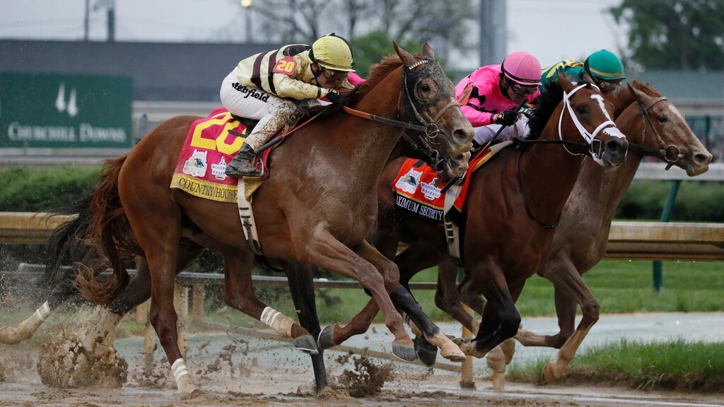 CORRECTS MAXIMUM SECURITY DISQUALIFIED, ADDS WINNER COUNTRY HOUSE - Luis Saez rides Maximum Security, center, crosses the finish line first ahead of Country House, left, and jockey Flavien Prat, during the 145th running of the Kentucky Derby horse race at Churchill Downs Saturday, May 4, 2019, in Louisville, Ky. Country House was declared the winner after Maximum Security was disqualified following a review by race stewards. (AP Photo/John Minchillo)