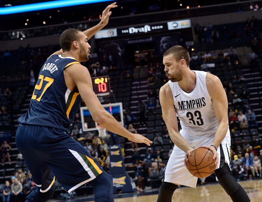 Memphis Grizzlies center Marc Gasol (33) controls the ball next to Utah Jazz center Rudy Gobert (27) during the first half of an NBA basketball game Wednesday, Feb. 7, 2018, in Memphis, Tenn. (AP Photo/Brandon Dill)