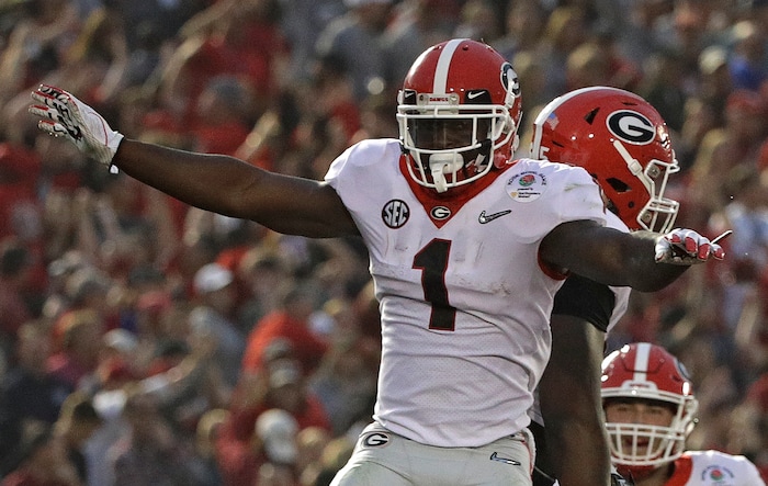 Georgia running back Sony Michel (1) celebrates with offensive tackle Kendall Baker, right, after Michel scored a touchdown against Oklahoma during the second half of the Rose Bowl NCAA college football game Monday, Jan. 1, 2018, in Pasadena, Calif. (AP Photo/Jae C. Hong)