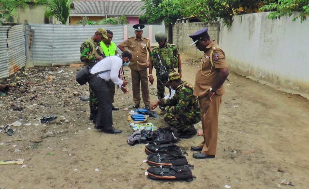 (AP Photo/Achala Upendra) Sri Lankan police and army officers display gelatin sticks, detonators, back packs and other bomb making material recovered from the hide out of militants after Friday's gun battle in Kalmunai, in eastern Sri Lanka Sri Lanka, Saturday, April 27, 2019. Militants linked to Easter suicide bombings opened fire and set off explosives during a raid by Sri Lankan security forces on a house in the country's east, leaving behind 15 bodies, including six children.