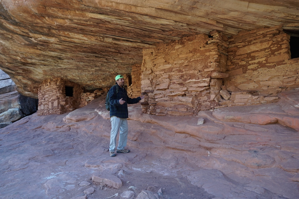 (Zak Podmore | The Salt Lake Tribune) Louis Williams, a Diné guide who runs Ancient Wayves River and Hiking Adventures in San Juan County, stands before the House on Fire cliff dwelling in Bears Ears National Monument on April 16, 2021. Tourists are overrunning ancient sites in the monument area.