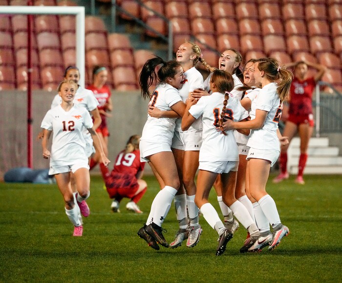 (Leah Hogsten | The Salt Lake Tribune) Mountain Crest  celebrates the win with teammate Summer Sofonia (13) after Crimson Cliffs' goalie Ellie Nielsen could not stop Sofonia's free kick during the 4A State Soccer Championship game between Mountain Crest High School and Crimson Cliffs High School, Oct. 22, 2021 at Rio Tinto Stadium. Mountain Crest defeated Crimson Cliffs 1-0 in double overtime.