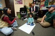 (Francisco Kjolseth  | The Salt Lake Tribune) Youth organizer Cynthia Ponce-Orellana brainstorms ideas to bringing a high school to the West side with Devin Martinez with daughter Belen, 2, and Alex Murphy. The Comunidades Unidas' Immigrant People's Agenda gathering, which looks to promote and advocate for immigrant rights, met in West Valley City on Friday, Nov. 1, 2024.