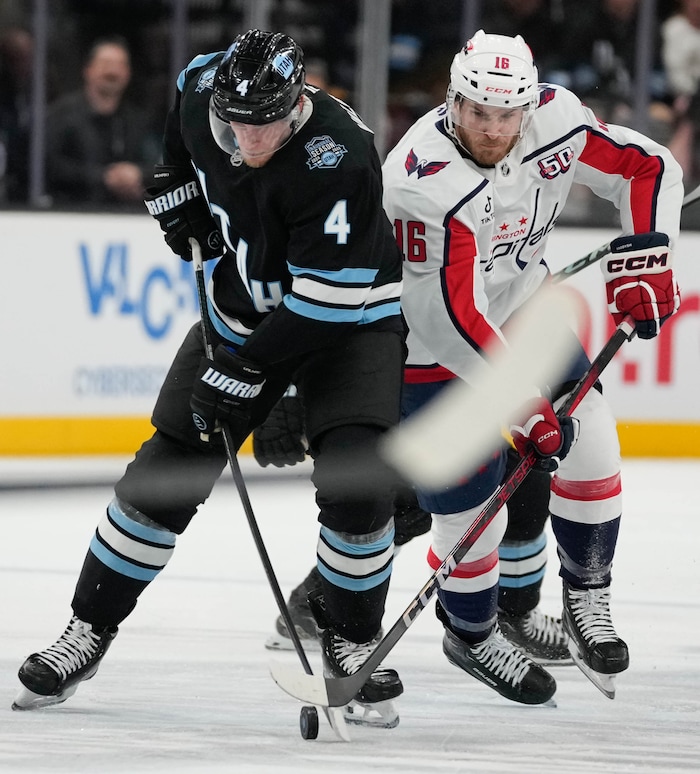 (Francisco Kjolseth | The Salt Lake Tribune) Utah Hockey Club defenseman Juuso Valimaki (4) is pressured by Washington Capitals right wing Taylor Raddysh (16) during an NHL hockey game at the Delta Center in Salt Lake City on Monday, Nov. 18, 2024.