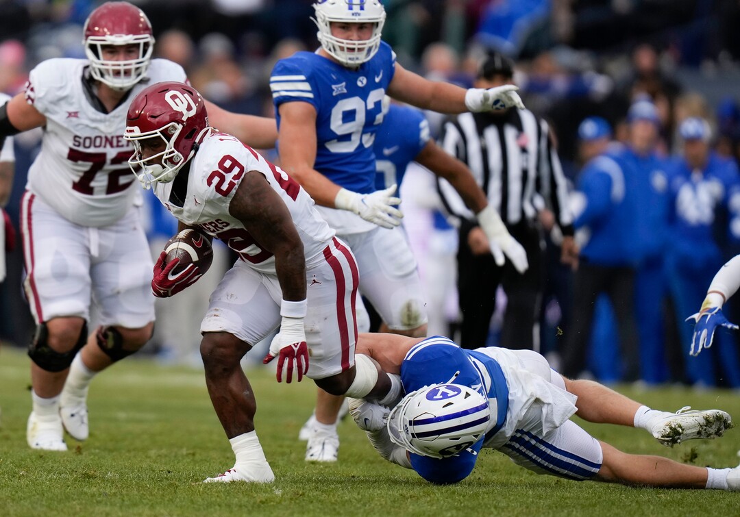 (Bethany Baker  |  The Salt Lake Tribune) Brigham Young Cougars safety Talan Alfrey (25) tackles Oklahoma Sooners running back Tawee Walker (29) at LaVell Edwards Stadium in Provo on Saturday, Nov. 18, 2023.
