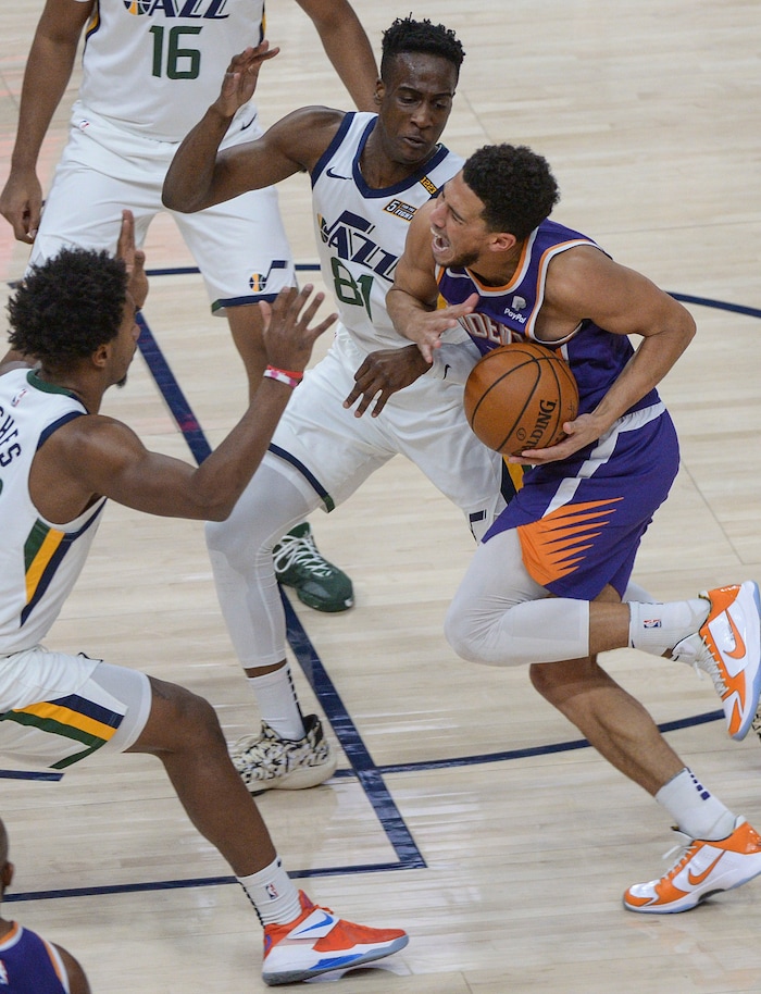 (Leah Hogsten | The Salt Lake Tribune) Utah Jazz guard Miye Oni (81) pressures Phoenix Suns guard Devin Booker (1) as the Jazz crack open their 2020-21 preseason with their second game against the Phoenix Suns, Dec. 14, 2020.