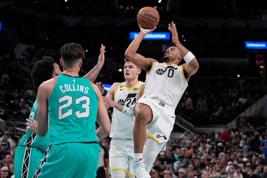 Utah Jazz guard Talen Horton-Tucker (0) shoots against the San Antonio Spurs during the second half of an NBA basketball game in San Antonio, Wednesday, March 29, 2023. (AP Photo/Eric Gay)