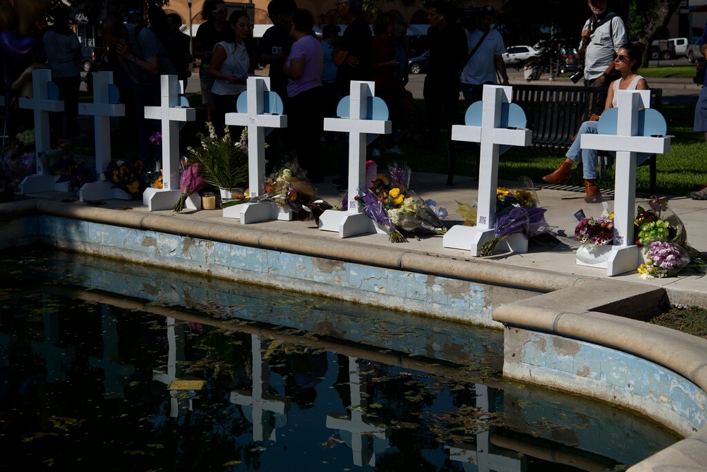 (Callaghan O'Hare | The New York Times)
Mourners gather near crosses bearing the names of those killed in Tuesday's mass shooting at Robb Elementary School in Uvalde, Texas, on Thursday, May 26, 2022. Thursday was supposed to have been the last day of school in Uvalde; instead, grieving relatives are planning funerals after a mass shooting for which investigators were still seeking a motive.