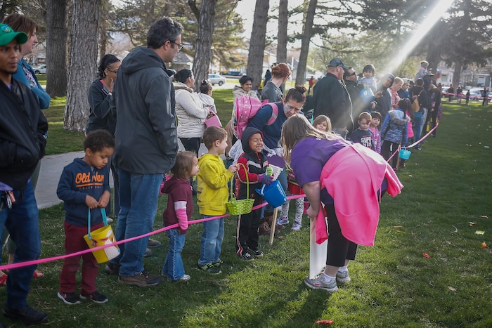 (Nicole Boliaux | For The Tribune) Children and their families wait for the stroke of 9 o'clock to begin the annual Easter egg hunt put on by A Kid's Place Dentistry in Liberty Park in Salt Lake City on Saturday, March 31, 2018.