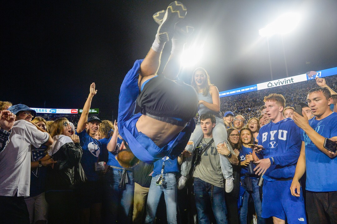 (Chris Samuels | The Salt Lake Tribune) Andrew Price from Rocklin, Calif., does a backflip as fans storm the field as the Brigham Young Cougars defeat the Utah Utes 26-17 in football, Saturday, Sept. 11, 2021 in Provo.