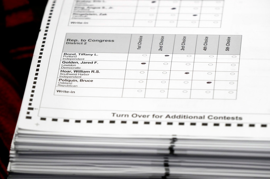 Ballots are prepared for recounting in Maine's 2nd Congressional District, Thursday, Dec. 6, 2018, in Augusta, Maine. The recount was requested by outgoing U.S. Rep. Bruce Poliquin after losing a November ranked-choice race to Rep.-elect Jared Golden. (AP Photo/Robert F. Bukaty)