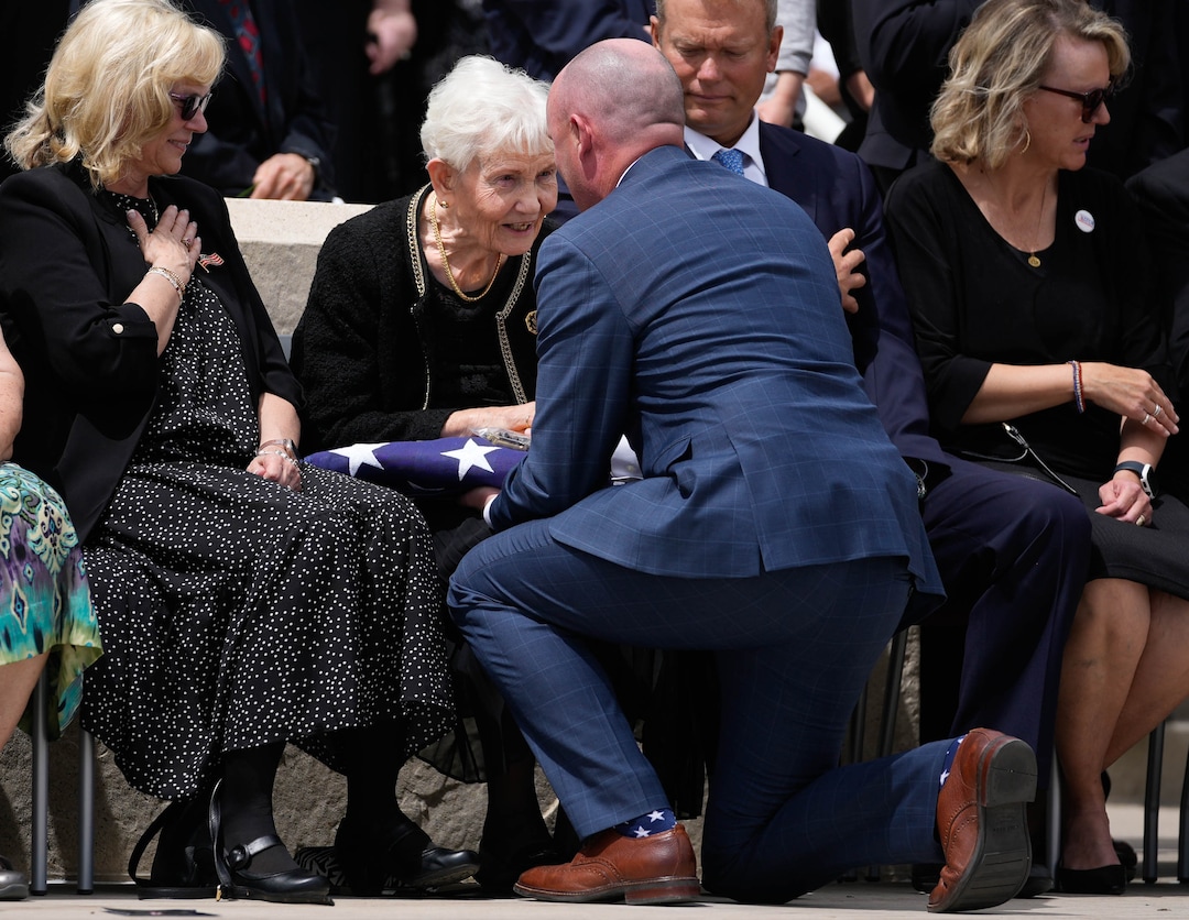 (Francisco Kjolseth | The Salt Lake Tribune) Elaine Hatch, wife of former U.S. Sen. Orrin Hatch, center, speaks with Gov. Spencer Cox as he gives her the flag that was draped over her husband’s casket as Hatches’ children, Marcia Hatch Whetton, left, Jess Hatch and Alysa Whitlock, look on after funeral services at the Institute of Religion on Friday, May 6, 2022. Hatch, the longest-serving Republican senator in U.S. history and the longest-serving from Utah, died April 23 at age 88.