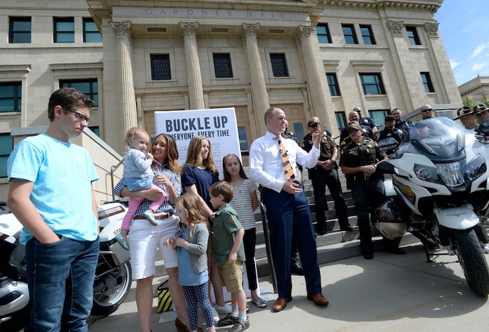 Al Hartmann photo
Justin Harding, Governor Herbert’s Chief of Staff, center, describes the force of impact of a head-on car accident this winter at a press conference Monday May 23 at Libby Gardner Hall. The Harding family was on their way to the hall for music rehearsal with his family when a car turned in front of them and hit them head on. He credits the decision of wearing seat belts, booster and infant car seats for saving his life and the lives of his four children. They were shaken up but mostly uninjured. Harding, his family and members of law enforcement were there to encourage seat belt use. Utah kicks off its annual Click It or Ticket campaign to promote seat belt use starting today.