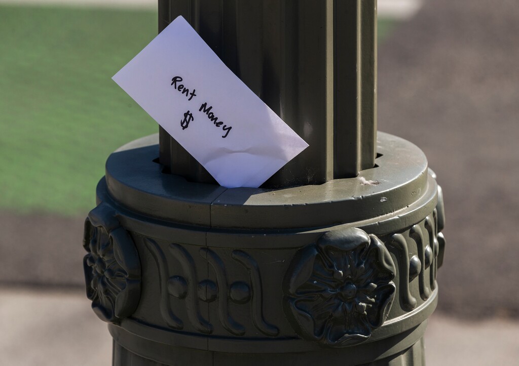 (Damian Dovarganes | AP file photo) In this April 1, 2020, file photo, a paper envelope written with the words "Rent Money $" is left tucked in a lighting pole in the Boyle Heights east district of the city of Los Angeles. In Utah, the state has opened a rental aid program to people receiving unemployment benefits.