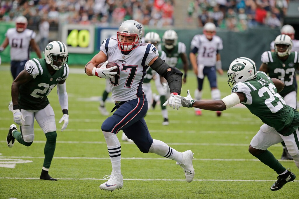 New England Patriots' Rob Gronkowski (87) runs away from New York Jets' Marcus Maye (26) and Morris Claiborne (21) for a touchdown during the second half of an NFL football game, Sunday, Oct. 15, 2017, in East Rutherford, N.J. (AP Photo/Seth Wenig)