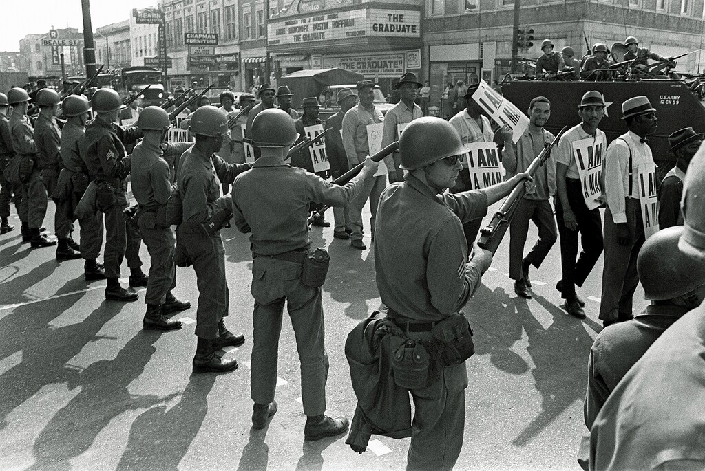 (Charlie Kelly | AP file photo)

In this March 29, 1968, photo, striking sanitation workers march past Tennessee National Guard troops with bayonets during a 20-block march to City Hall, one day after a similar march erupted in violence, leaving one person dead and several injured, in Memphis, Tenn. The Rev. Martin Luther King Jr. was assassinated April 4, 1968, while in Memphis supporting striking sanitation workers.