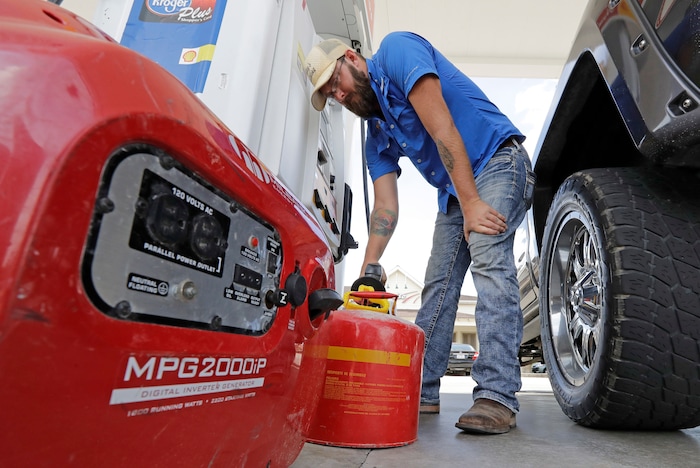 (David J. Phillip | The Associated Press) Aaron Berg fills up a gas can and his portable generator Thursday, Aug. 24, 2017, in Houston, as Hurricane Harvey intensifies in the Gulf of Mexico. Hurricane Harvey is expected to hit a refinery-rich stretch of the Gulf Coast and U.S. drivers could soon see the impact at the gas pump.