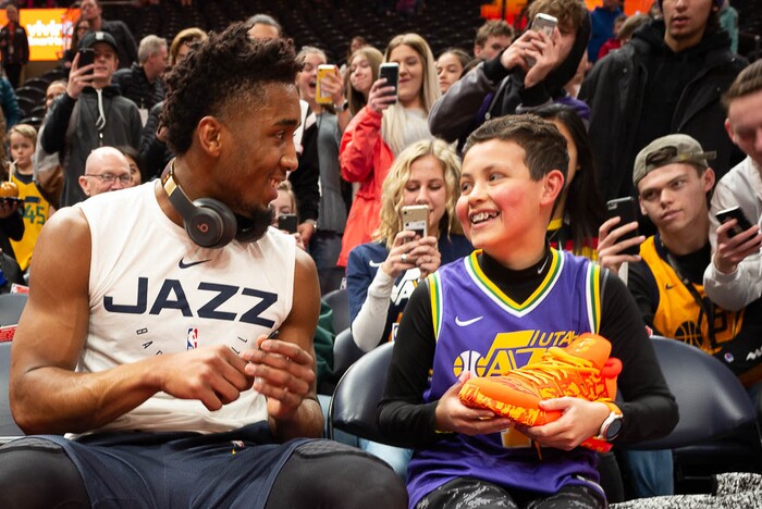 (Trent Nelson | The Salt Lake Tribune)  
Utah Jazz guard Donovan Mitchell (45) hands an autographed shoe to young fan Brigham Israelsen as the Utah Jazz prepare to host the San Antonio Spurs, NBA basketball in Salt Lake City on Saturday Feb. 9, 2019.