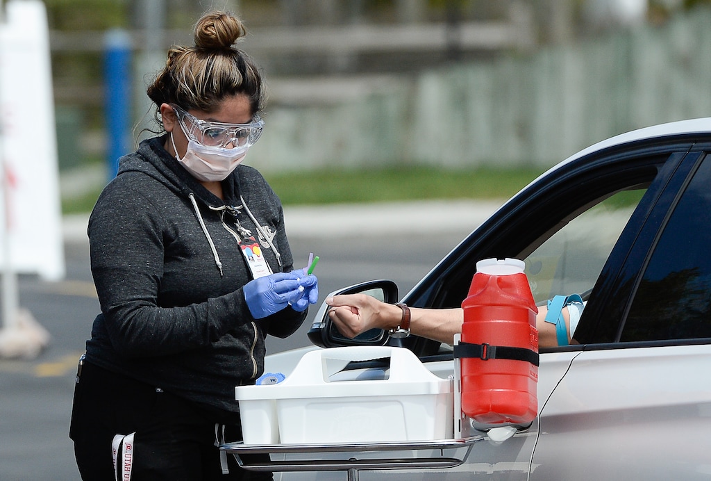 (Francisco Kjolseth | The Salt Lake Tribune file photo ) Phlebotomist Adriana Rodriguez performs a blood draw to test for coronavirus antibodies in Park City on Wednesday, May 6, 2020, as part of the Utah HERO (Health & Economic Recovery Outreach) program. The massive undertaking will begin with randomized testing of 10,000 Utahns across four counties. The data gathered will inform decision-makers in the state as they work to help keep residents safe and get people back to work.