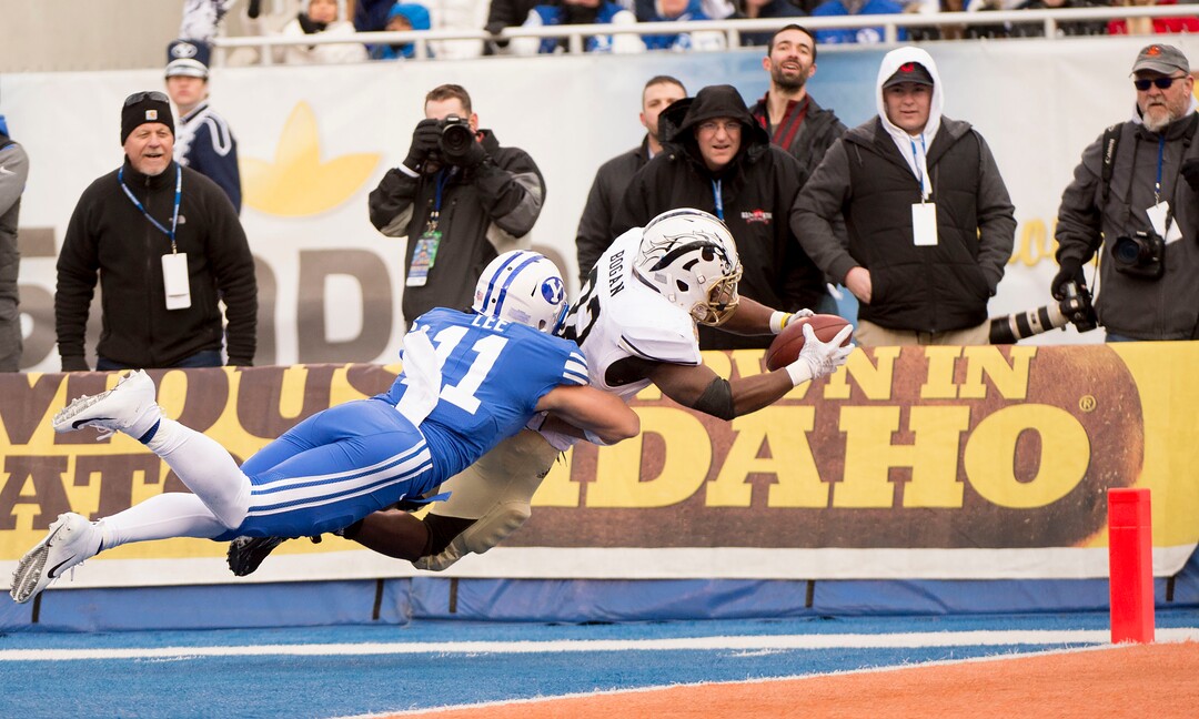 (Jeremy Harmon  |  The Salt Lake Tribune) Western Michigan Broncos running back Jamauri Bogan (32) dives for a touchdown under pressure for Brigham Young Cougars defensive back Austin Lee (11) as BYU faces the Western Michigan Broncos in the Famous Idaho Potato Bowl in Boise, Idaho, on Friday, Dec. 21, 2018.