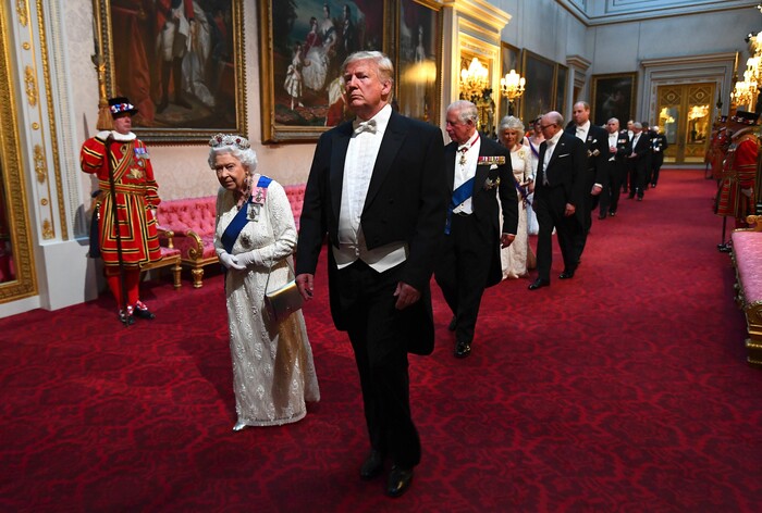 Britain's Queen Elizabeth II, centre left and US President Donald Trump and guests arrive through the East Gallery ahead of the State Banquet at Buckingham Palace in London, Monday, June 3, 2019. Trump is on a three-day state visit to Britain. (Victoria Jones/Pool Photo via AP)