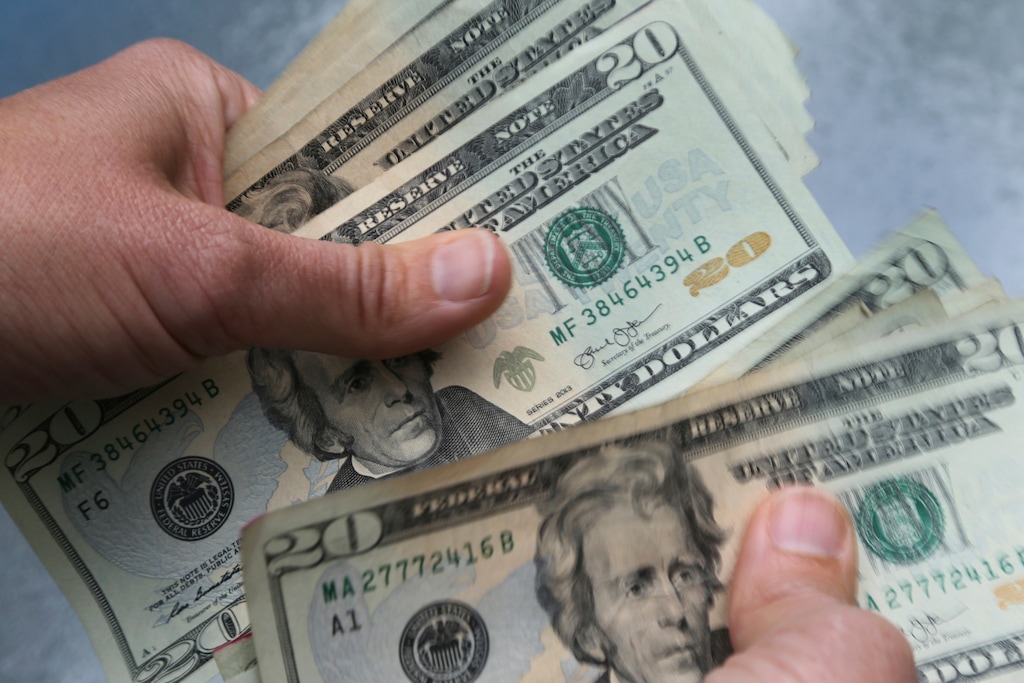 FILE - In this June 15, 2018, file photo, 20-dollar bills are counted in North Andover, Mass. (AP Photo/Elise Amendola, File)