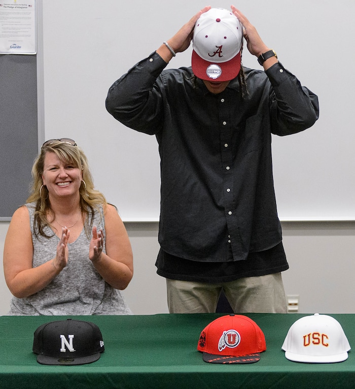 (Trent Nelson  |  The Salt Lake Tribune)  Olympus tight end Cameron Latu announces he's headed to Alabama during a news conference at Olympus High School in Salt Lake City Friday August 4, 2017. His mother Jill Argust is at left.