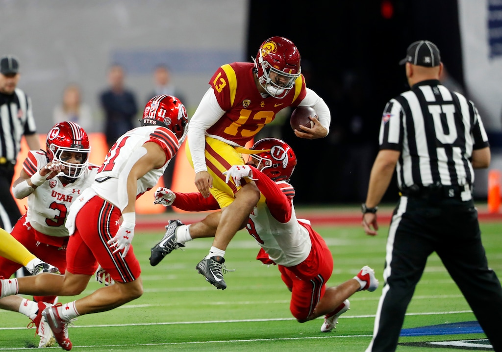 (Steve Marcus | AP) Southern California quarterback Caleb Williams (13) is tackled by Utah safeties R.J. Hubert (11) and Cole Bishop (8) during the first half of the Pac-12 Conference championship NCAA college football game Friday, Dec. 2, 2022, in Las Vegas.