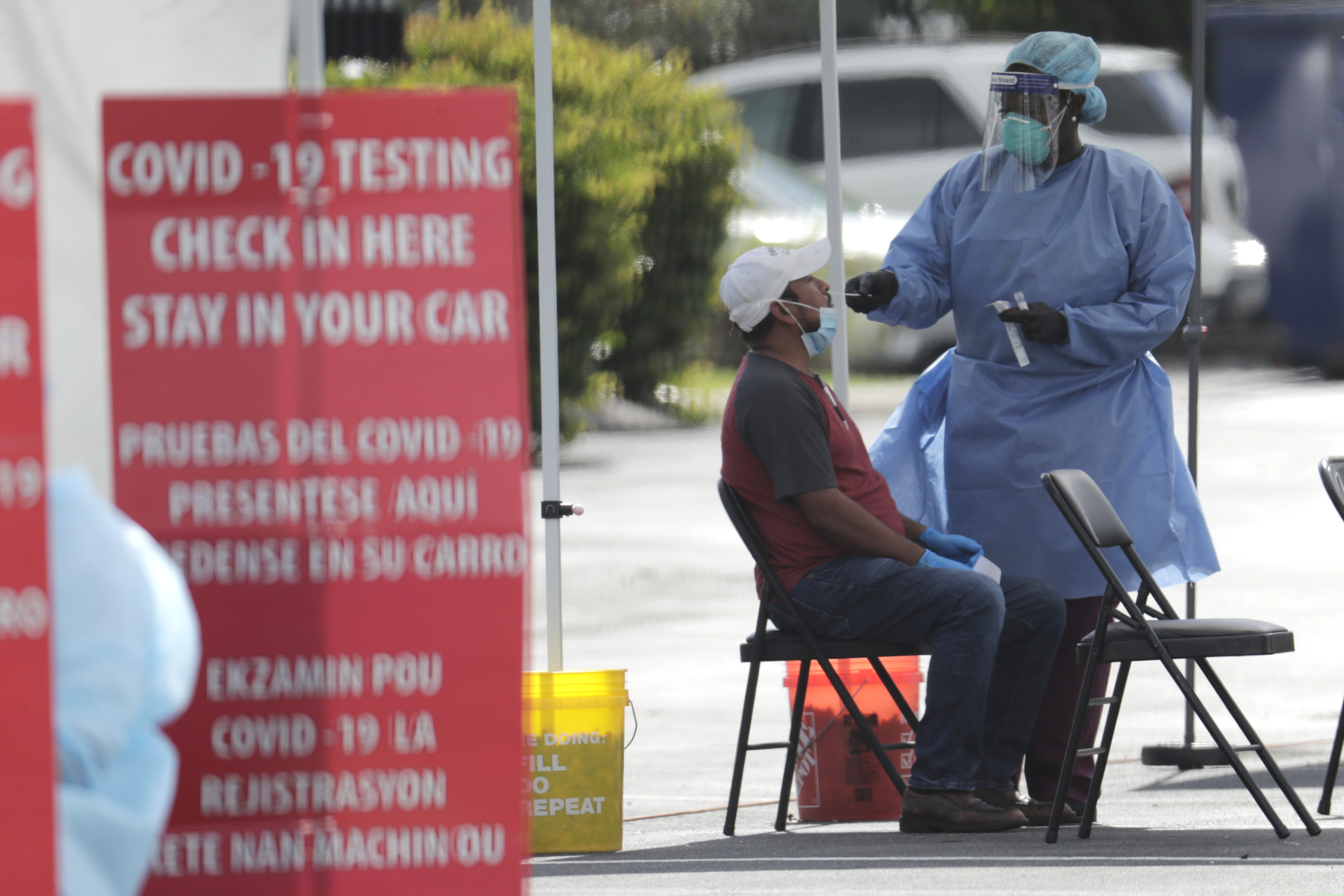 (Lynne Sladky | AP photo)

In this July 6 photo, a health care worker administers a COVID-19 test at a site sponsored by Community Health of South Florida at the Martin Luther King, Jr. Clinica Campesina Health Center in Homestead, Fla.