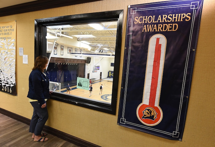 (Francisco Kjolseth  |  The Salt Lake Tribune)  Robyn Ellis, Director of Lindon charter school Karl G. Maeser Preparatory Academy in Lindon, overlooks the the high school gym as a poster illustrates the nearly 2-million in scholarship funding awarded to their students so far on Tuesday, May 8, 2018. The academy was named Utah's best high school by U.S. News and World Report.