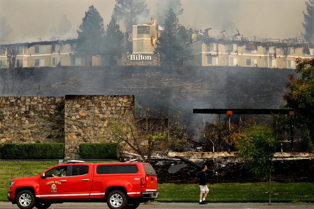 A fire burns at a Hilton hotel on Monday, Oct. 9, 2017, in Santa Rosa, Calif. Wildfires whipped by powerful winds swept through Northern California sending residents on a headlong flight to safety through smoke and flames as homes burned. (AP Photo/Ben Margot)