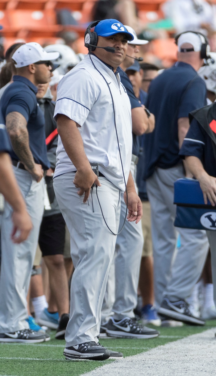 BYU head coach Kalani Sitake looks up at the scoreboard in the first quarter of an NCAA college football game against Hawaii, Saturday, Nov. 25, 2017, in Honolulu. (AP Photo/Eugene Tanner)