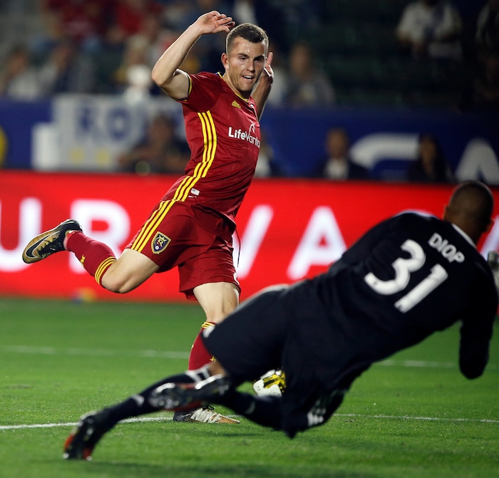 Real Salt Lake forward Brooks Lennon, left, has his point blank shot blocked by Los Angeles Galaxy goalkeeper Clement Diop during the second half of an MLS soccer game in Carson, Calif., Saturday, Sept. 30, 2017. (AP Photo/Alex Gallardo)