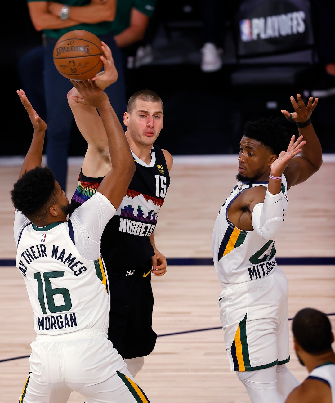 Denver Nuggets' Nikola Jokic tries to pass the ball as Utah Jazz's Juwan Morgan, left, defends during the second quarter of Game 5 of an NBA basketball first-round playoff series, Tuesday, Aug. 25, 2020, in Lake Buena Vista, Fla. (Mike Ehrmann/Pool Photo via AP)