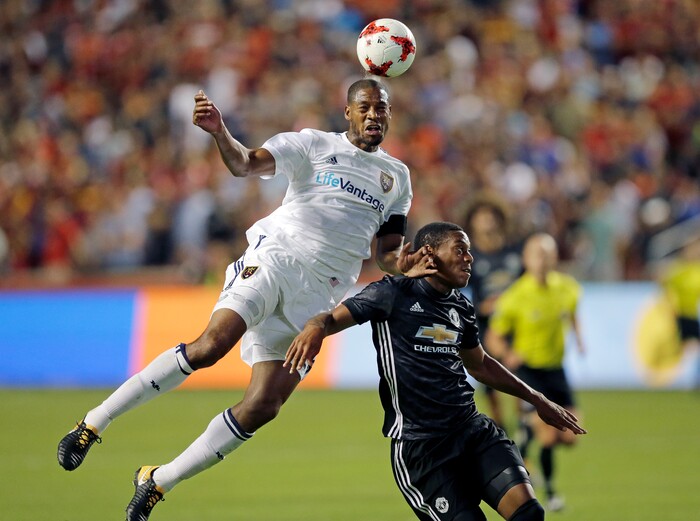 Real Salt Lake defender Chris Schuler, left, heads the ball as Manchester United forward Anthony Martial (11) defends during the second half of a friendly soccer match Monday, July 17, 2017, in Sandy, Utah. (AP Photo/Rick Bowmer)