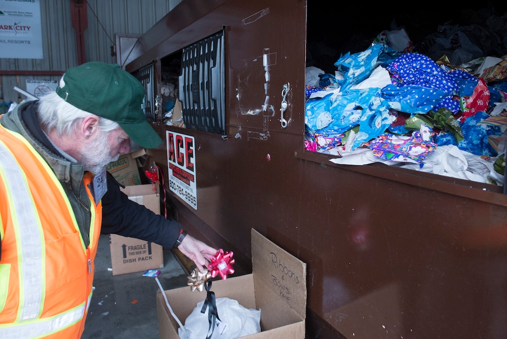(Rick Egan | The Salt Lake Tribune) Bruce Erickson, sorts through the Christmas debris, and pulls out the ribbons and bows, at Recycle Utah's Park City facility, Friday, December 26, 2014