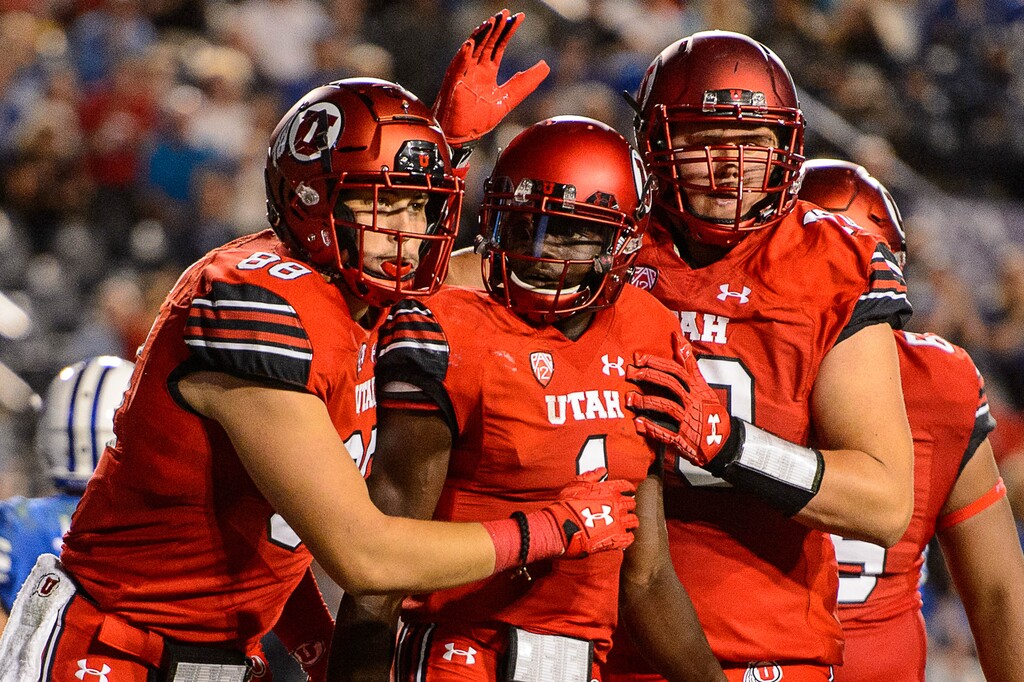 (Trent Nelson | The Salt Lake Tribune)  Utah Utes quarterback Tyler Huntley (1) celebrates a third quarter touchdown as BYU hosts Utah, NCAA football in Provo, Saturday September 9, 2017.