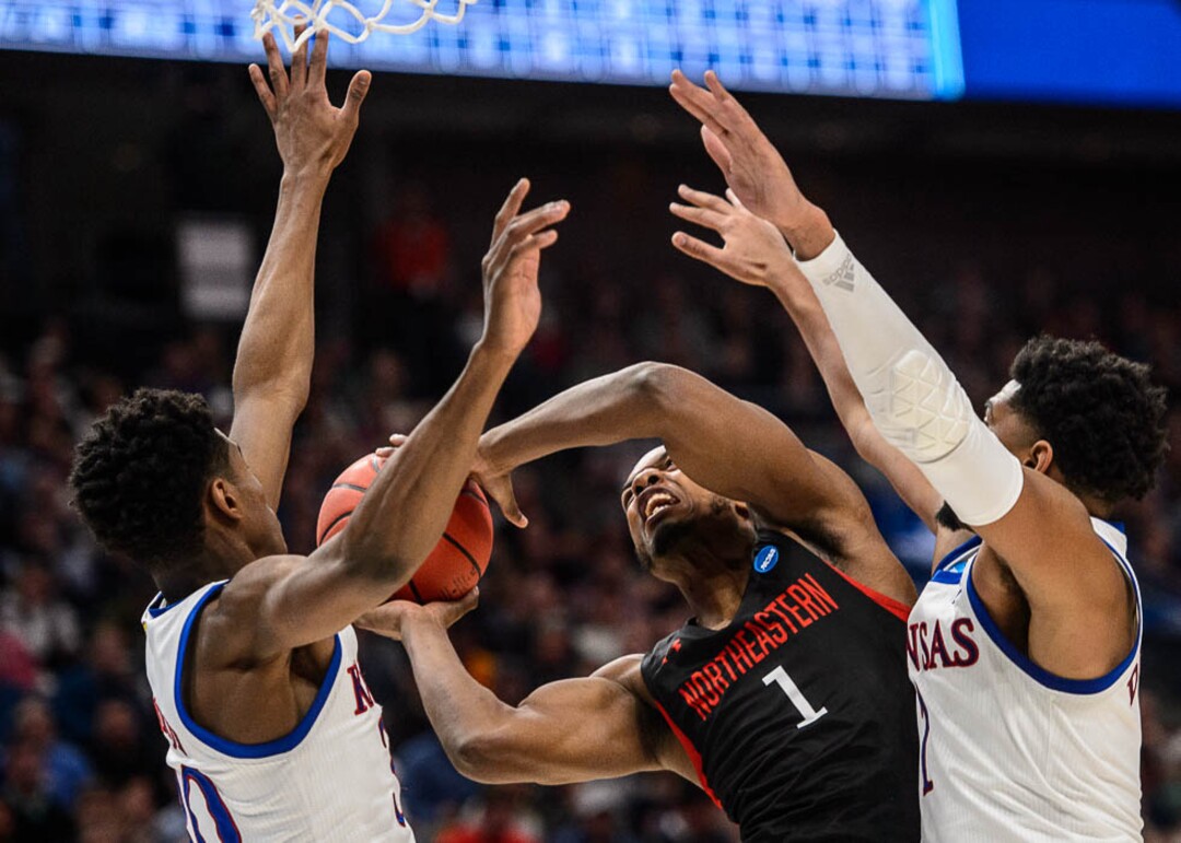 (Trent Nelson | The Salt Lake Tribune)  Northeastern Huskies guard Shawn Occeus (1) defended by Kansas Jayhawks guard Ochai Agbaji (30) and Kansas Jayhawks forward Dedric Lawson (1) as Kansas faces Northeastern in the 2019 NCAA Tournament in Salt Lake City on Thursday March 21, 2019.