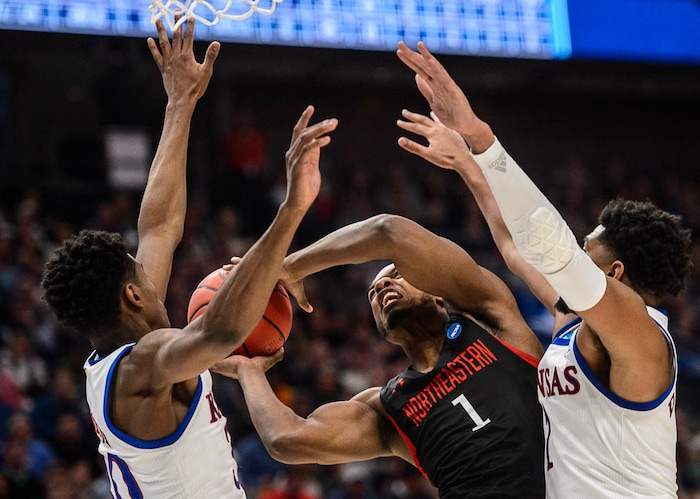 (Trent Nelson | The Salt Lake Tribune)  
Northeastern Huskies guard Shawn Occeus (1) defended by Kansas Jayhawks guard Ochai Agbaji (30) and Kansas Jayhawks forward Dedric Lawson (1) as Kansas faces Northeastern in the 2019 NCAA Tournament in Salt Lake City on Thursday March 21, 2019.