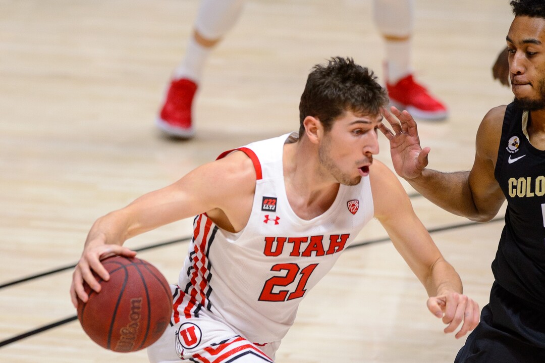(Trent Nelson  |  The Salt Lake Tribune) Utah Utes forward Riley Battin (21) drives on Colorado Buffaloes guard D'Shawn Schwartz (5) as Utah hosts Colorado, NCAA basketball in Salt Lake City on Monday, Jan. 11, 2021.