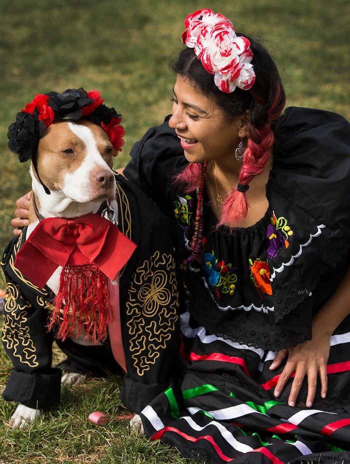 (Leah Hogsten  |  The Salt Lake Tribune)  Lola, 9, wears her owner Sol Villasenior's Mariachi suit that Villasenior wore when she was a little girl as the two pose for pictures during the 2017 Strut Your Mutt dog walk and fundraiser to save the lives of homeless pets, October 14, 2017  at Liberty Park. Participants can choose to raise money for Best Friends or for one of hundreds of participating shelters, rescue groups and other animal welfare groups. 