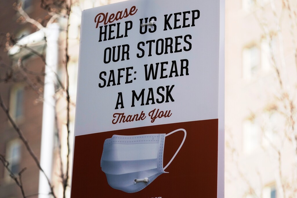 A sign requiring face masks is seen at Harmons Grocery store Monday, March 8, 2021, in Salt Lake City. Utah's statewide mask mandate will be lifted on April 10 under a measure that passed the full Legislature Friday, March 5, 2021. Republican Gov. Spencer Cox has said he plans to sign the bill. The bill lays out a new timeline for when Utah's COVID-19 restrictions applying to businesses, events, and schools would end. The mask mandate would still apply to gatherings of more than 50 people. (AP Photo/Rick Bowmer)